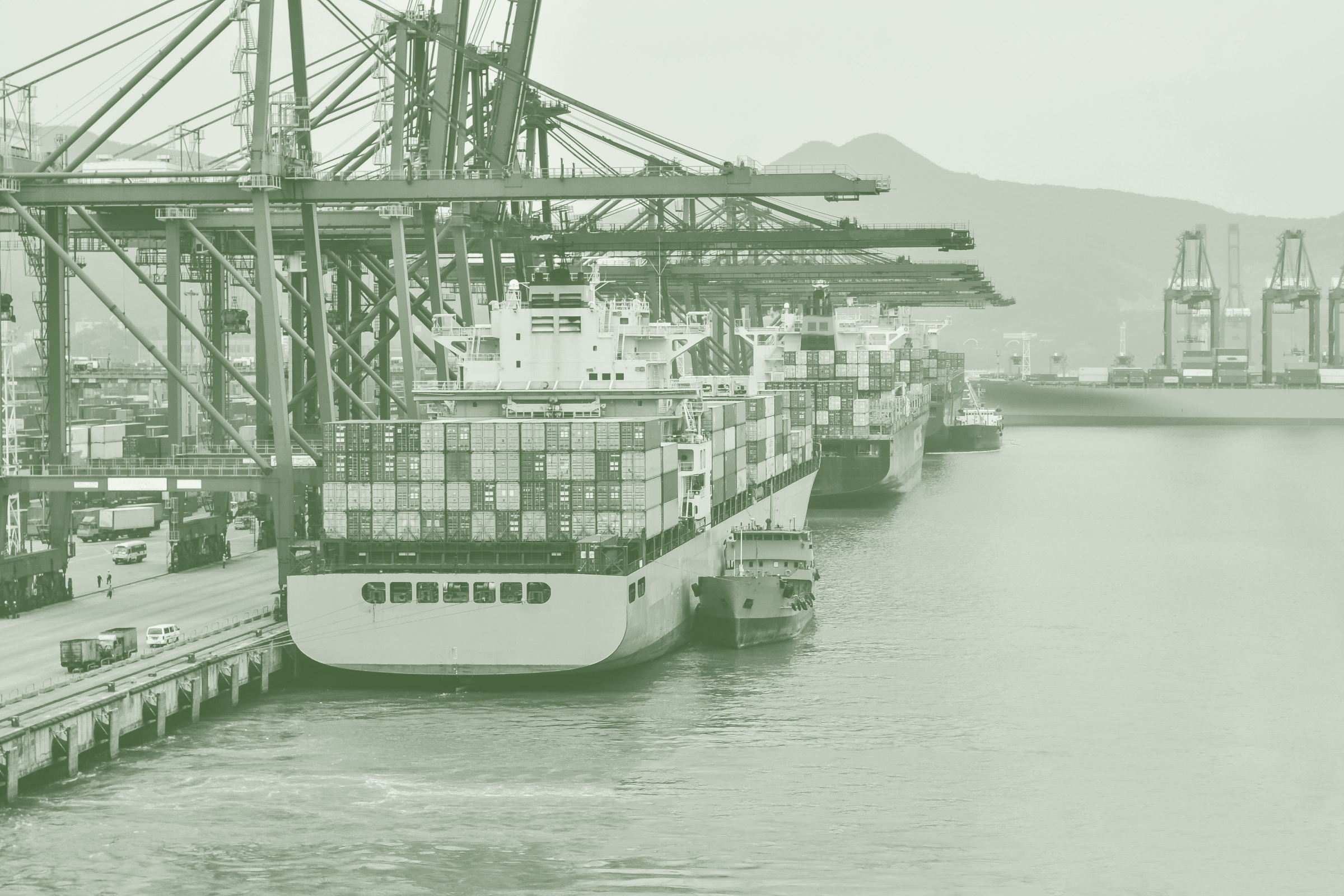 Container ship unloading cargo at a commercial port supported by trade finance solutions